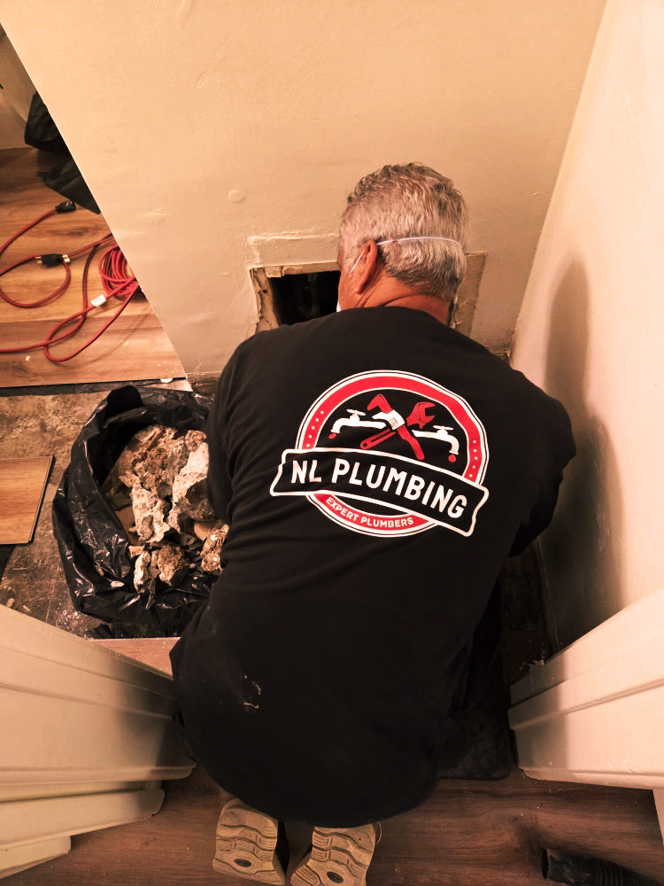 Technician performing plumbing repair